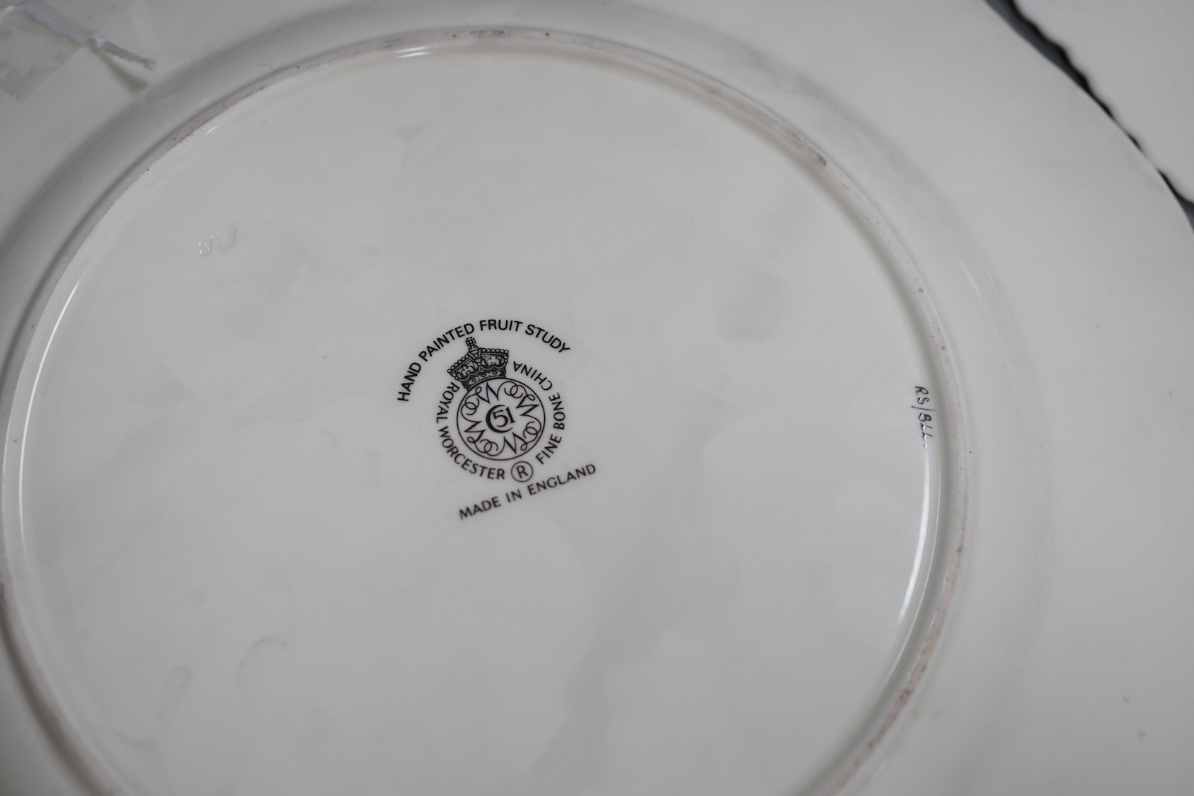 A pair of Royal Worcester fruit painted dinner plates, post war, by D. Shinnie and T. Nutt, 27cm diameter